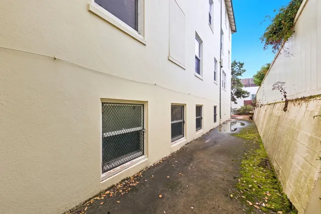 a large bedroom with a bed and a large window