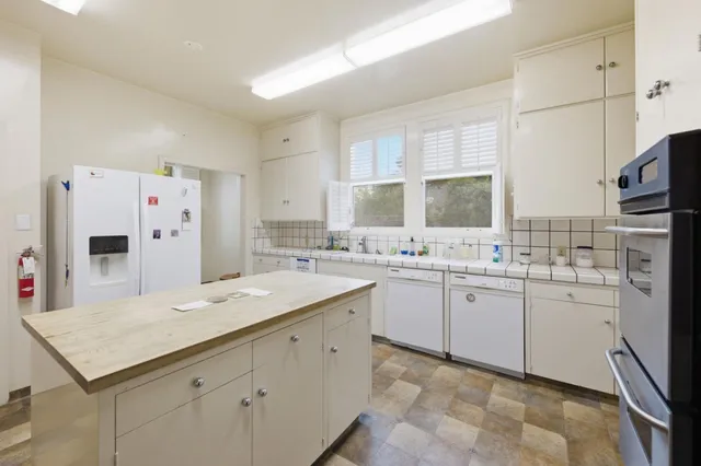 a living room with furniture a window and a flat screen tv
