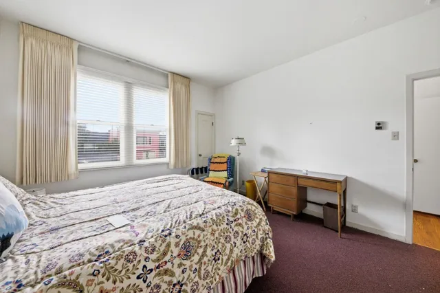 a view of a livingroom with furniture and a window