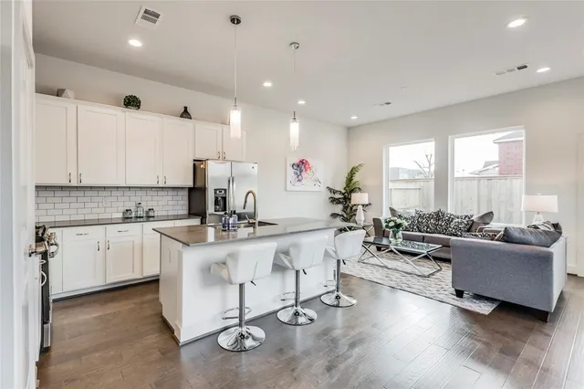a kitchen with counter top space a sink cabinets and appliances