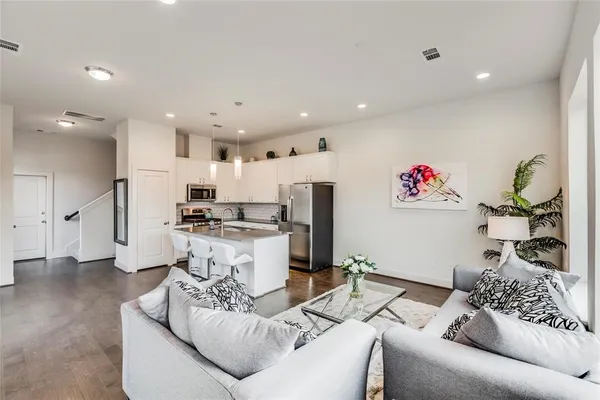 a living room with furniture and kitchen view