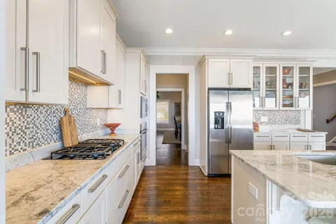 a kitchen with granite countertop cabinets stainless steel appliances and a counter space