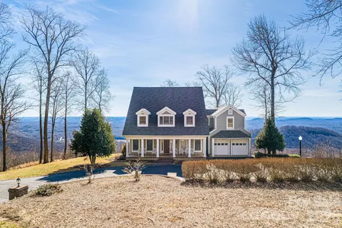 a front view of a house with a yard covered with snow