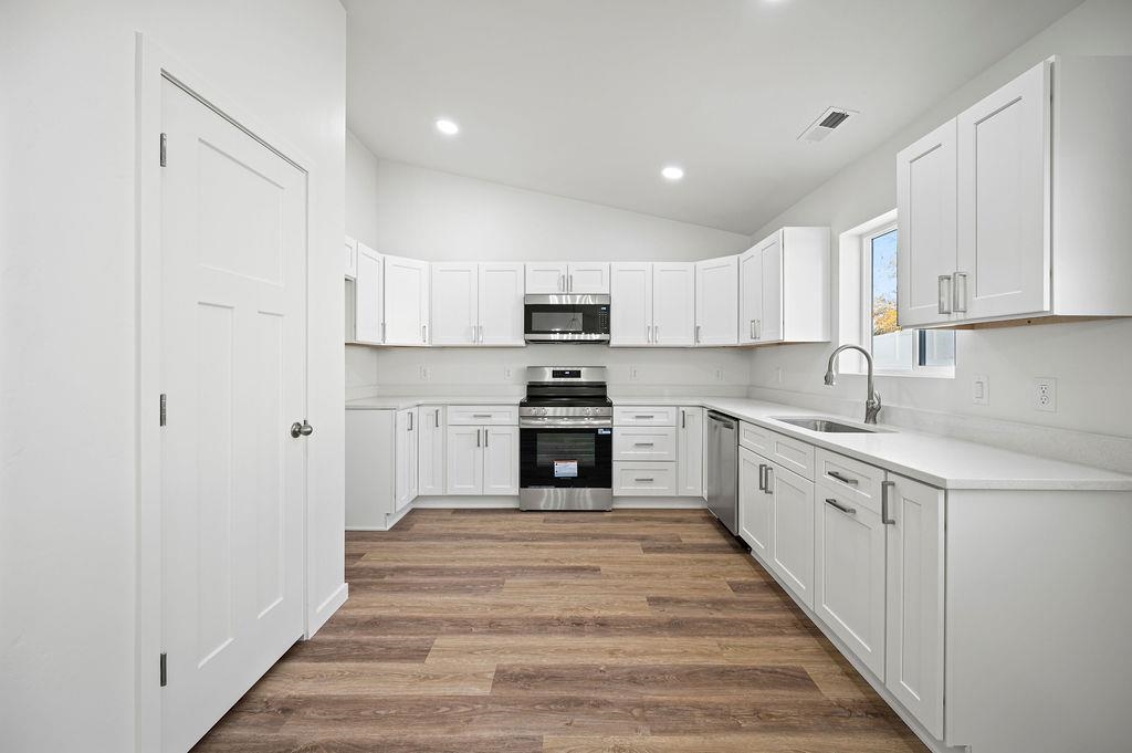 164 Orchard View Way Grand Junction, CO 81503 - Photo 11 of 24 a kitchen with granite countertop white cabinets and stainless steel appliances