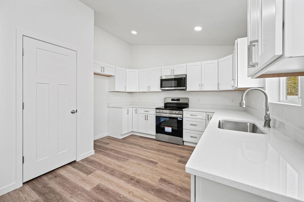 164 Orchard View Way Grand Junction, CO 81503 - Photo 12 of 24 a kitchen with wooden cabinets and a sink