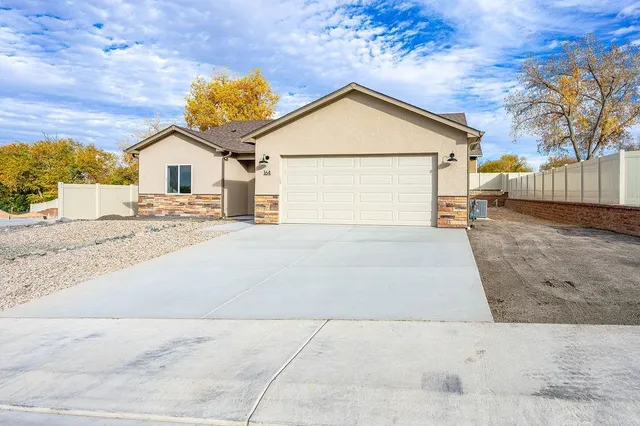 a view of a house with a yard and garage
