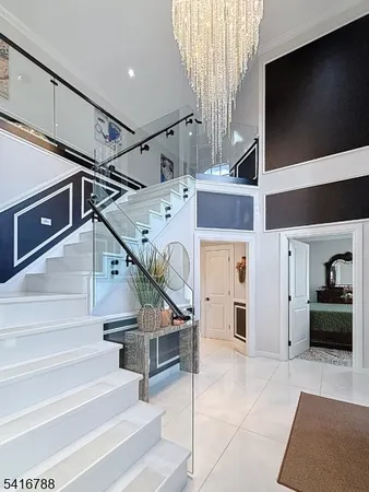 a large white kitchen with cabinets a sink a window and stainless steel appliances