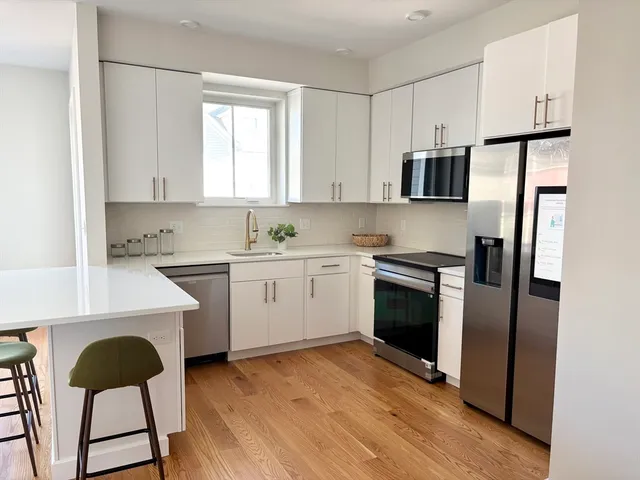 a kitchen with stainless steel appliances a refrigerator sink and cabinets