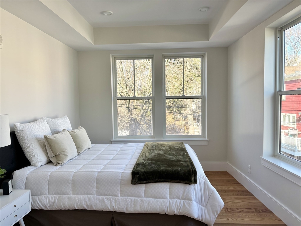 421 High Street, Unit 203 Medford, MA 02155 - Photo 10 of 19 a bedroom with a bed and a window