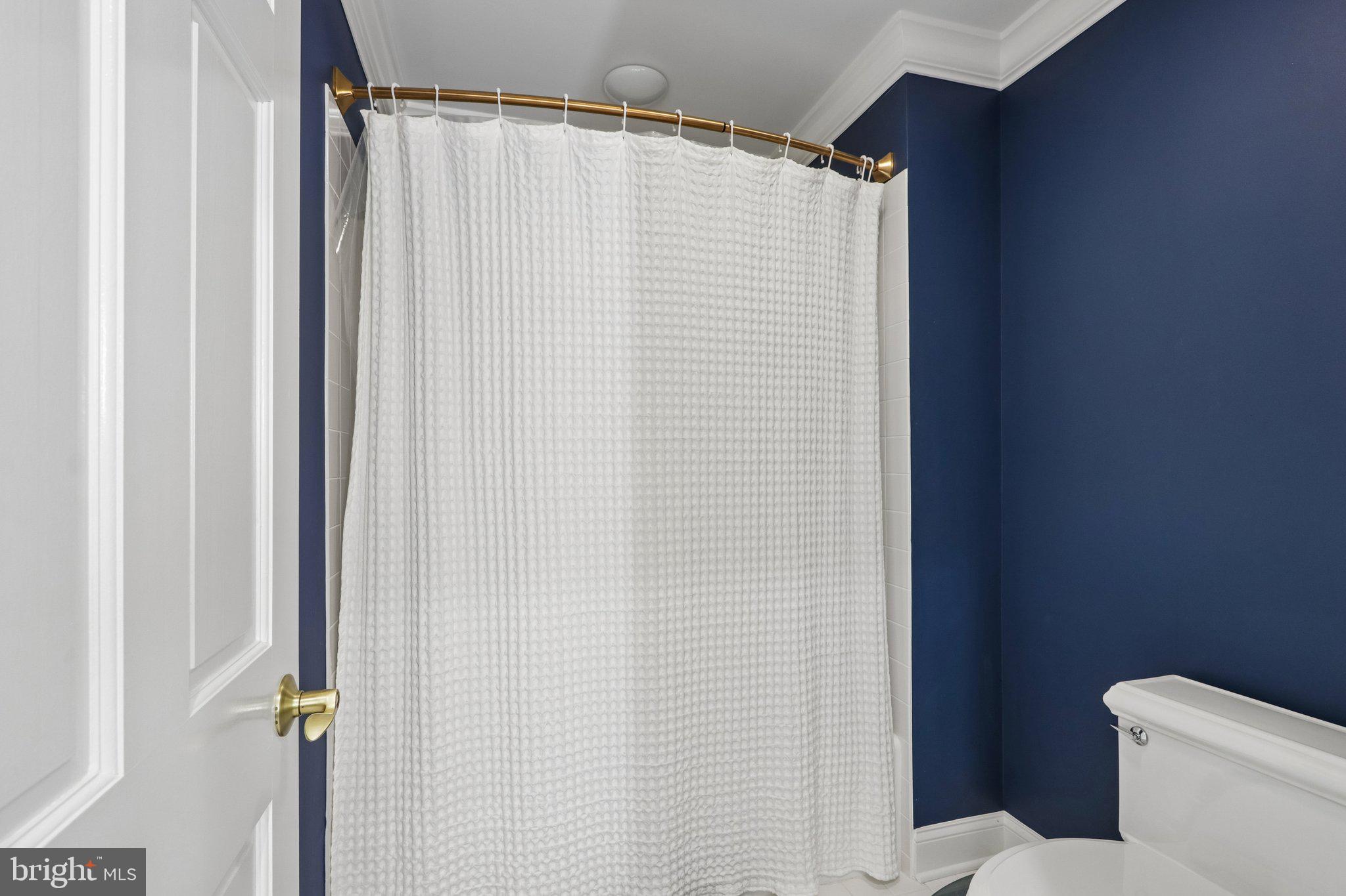 209 Welsh Road Ambler, PA 19002 - Photo 58 of 80 a bathroom with a shower curtain and a sink