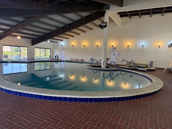 a view of a swimming pool with a dining table