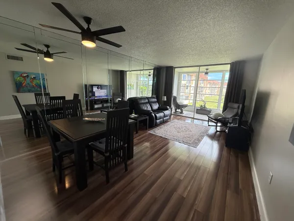 a view of a dining room with furniture window and wooden floor