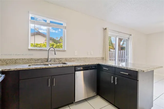 a kitchen with granite countertop a sink and a window
