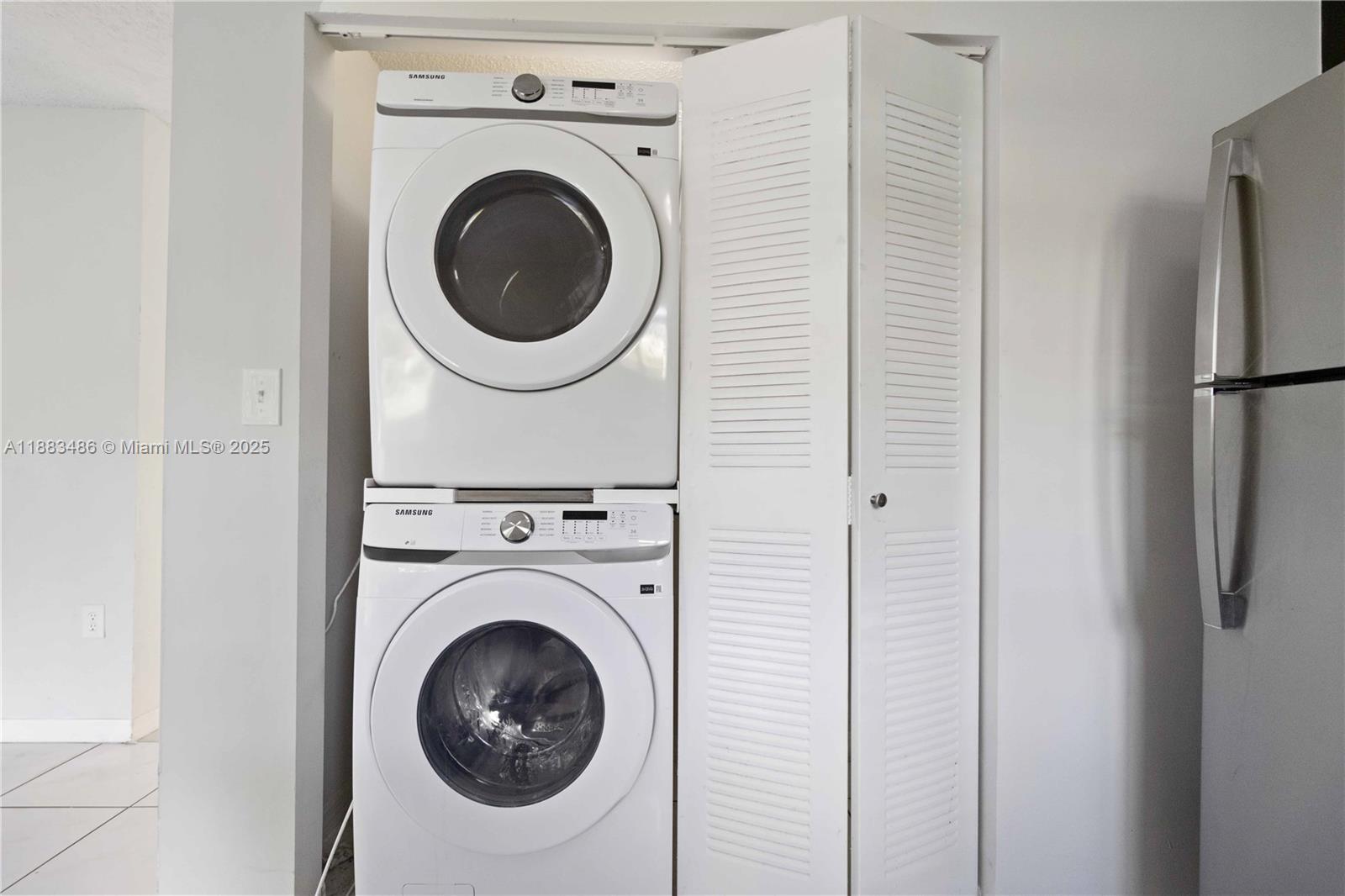 8431 Northwest 188th Terrace, Unit 8058 Hialeah, FL 33015 - Photo 15 of 34 a utility room with dryer and washer