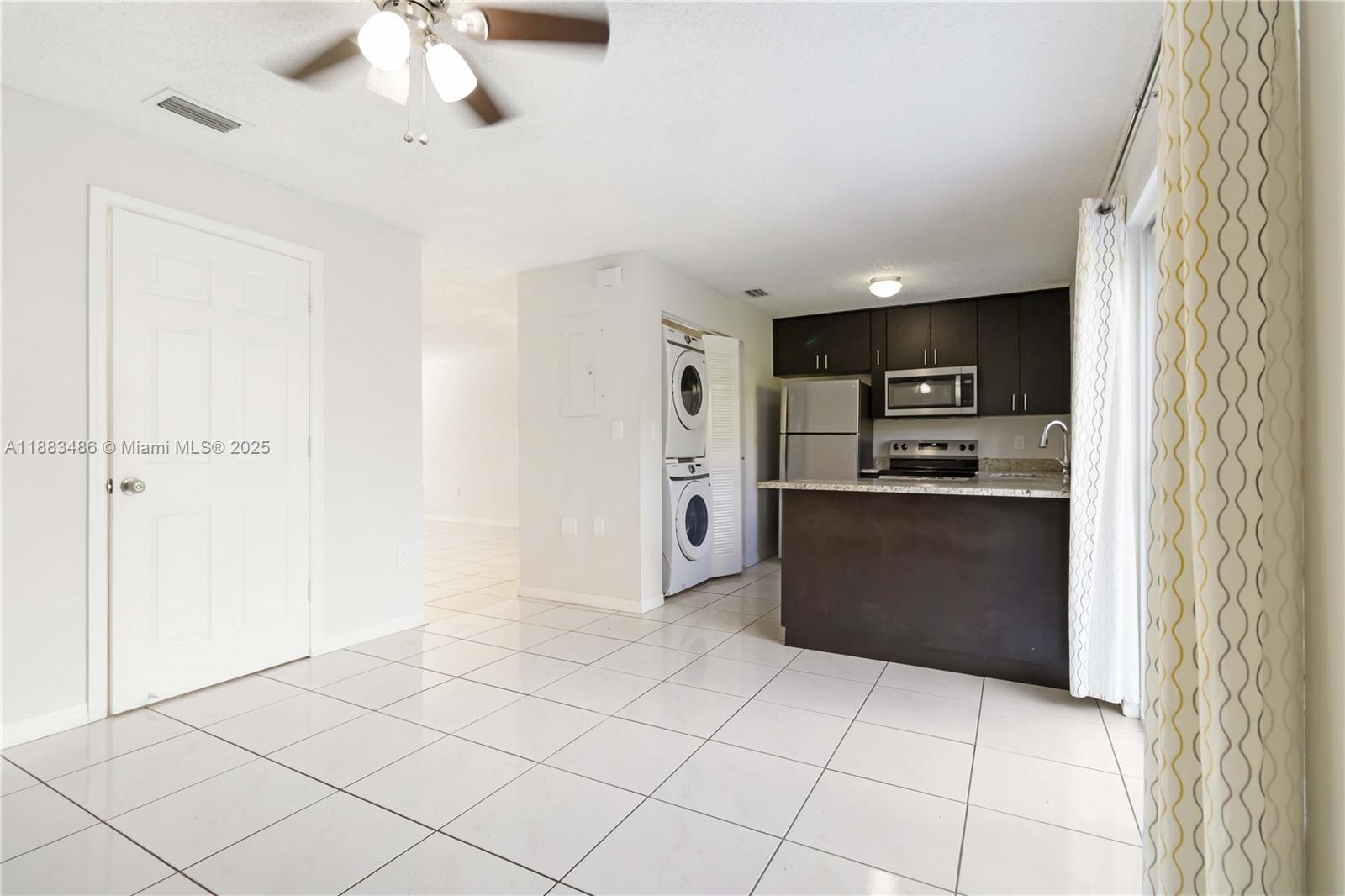 8431 Northwest 188th Terrace, Unit 8058 Hialeah, FL 33015 - Photo 16 of 34 a kitchen with stainless steel appliances a refrigerator and a stove top oven