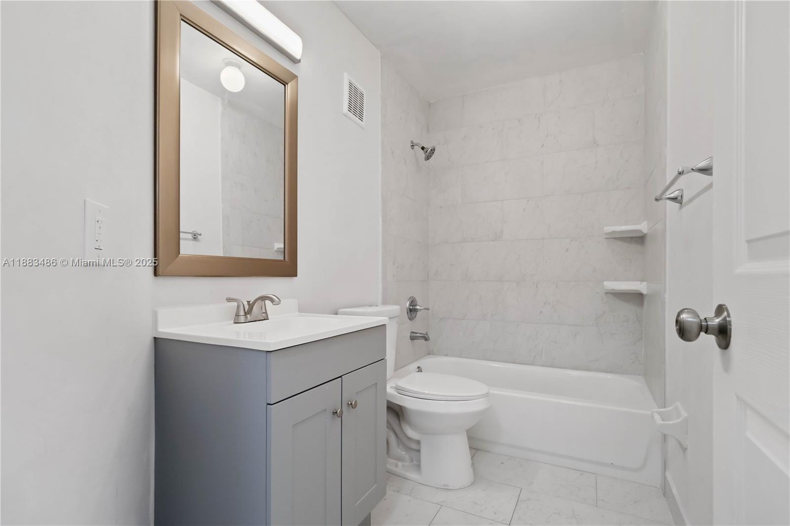 8431 Northwest 188th Terrace, Unit 8058 Hialeah, FL 33015 - Photo 18 of 34 a bathroom with a sink toilet and shower
