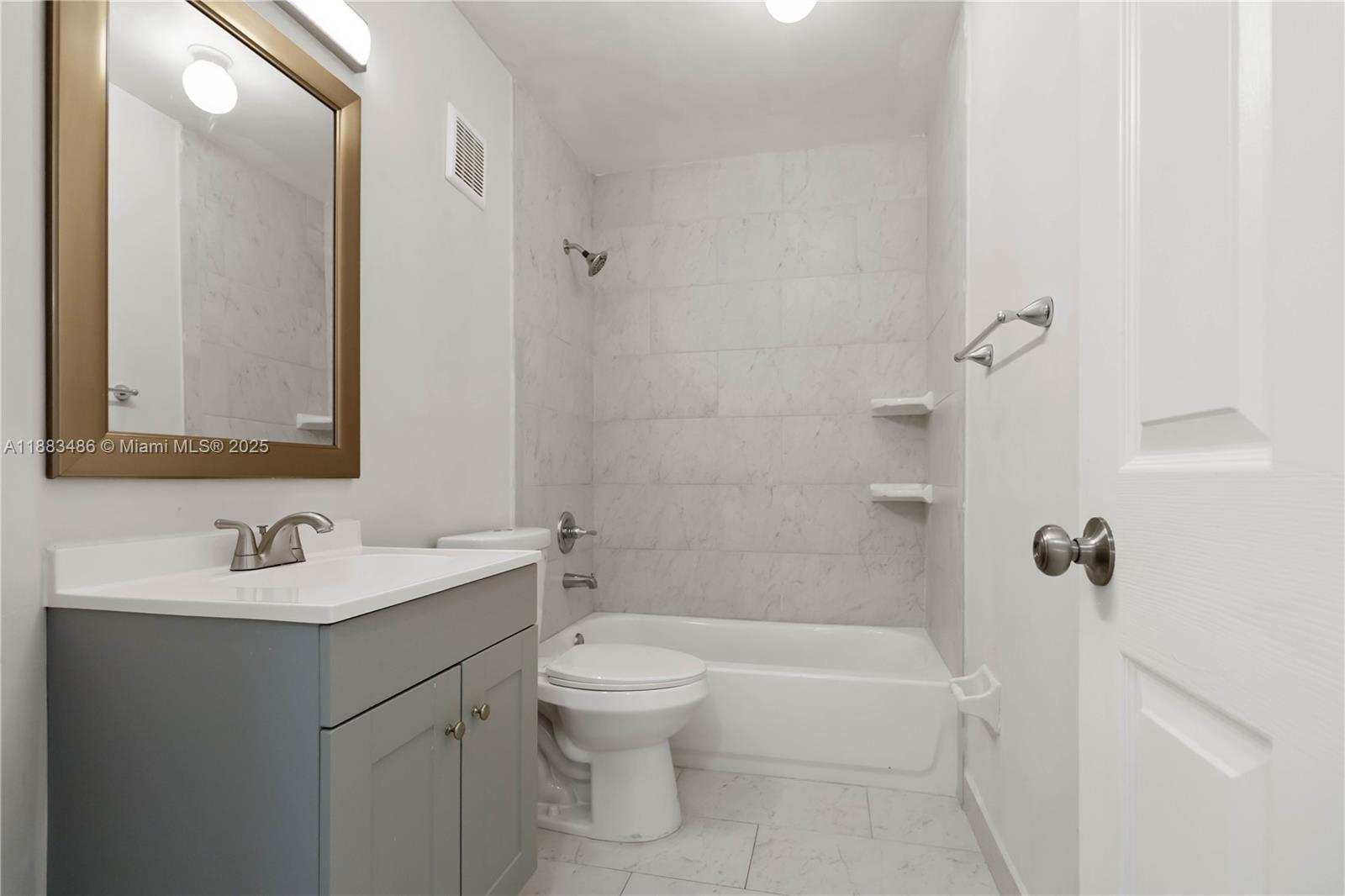 8431 Northwest 188th Terrace, Unit 8058 Hialeah, FL 33015 - Photo 19 of 34 a bathroom with a sink a toilet and shower