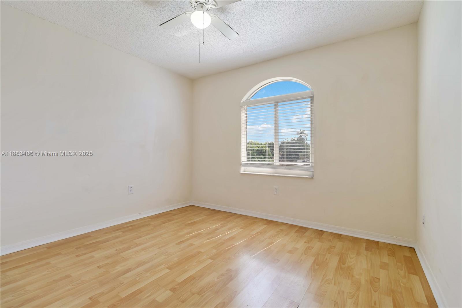 8431 Northwest 188th Terrace, Unit 8058 Hialeah, FL 33015 - Photo 20 of 34 wooden floor in an empty room with a window