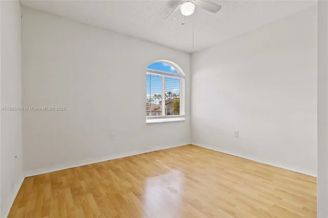 a view of a room with wooden floor and white walls