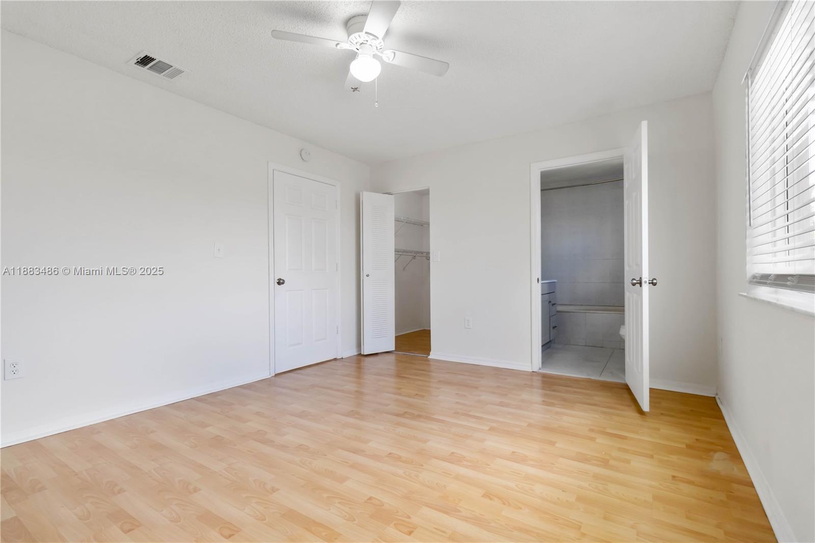 8431 Northwest 188th Terrace, Unit 8058 Hialeah, FL 33015 - Photo 25 of 34 a view of an empty room with a window