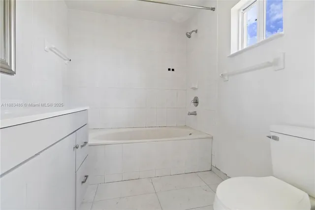 a bathroom with a toilet and a bathtub