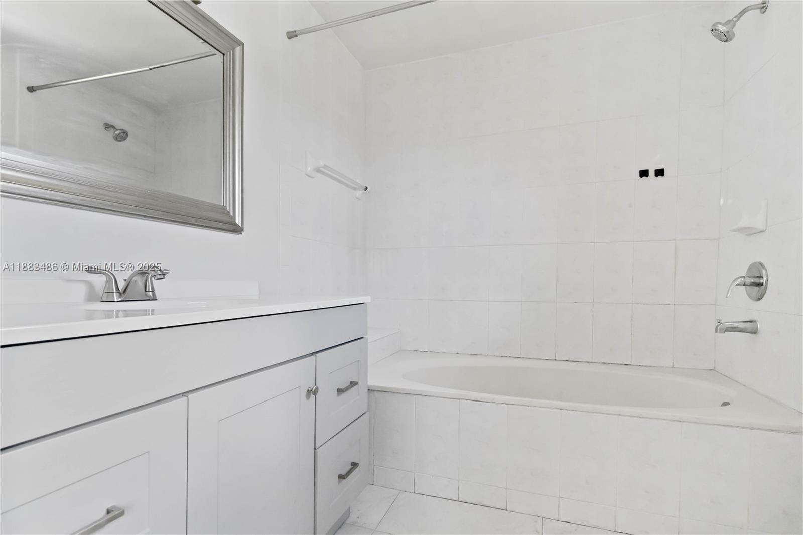 8431 Northwest 188th Terrace, Unit 8058 Hialeah, FL 33015 - Photo 27 of 34 a bathroom with a bathtub and a sink