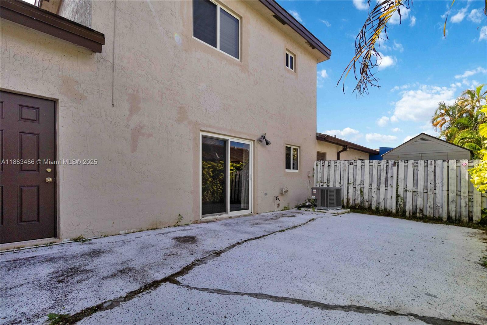 8431 Northwest 188th Terrace, Unit 8058 Hialeah, FL 33015 - Photo 32 of 34 a view of a house with a wooden fence