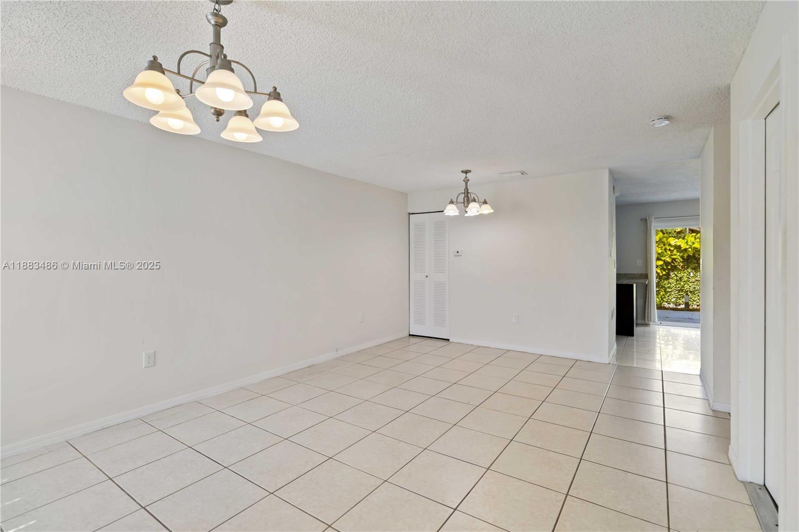8431 Northwest 188th Terrace, Unit 8058 Hialeah, FL 33015 - Photo 4 of 34 an empty room with kitchen view