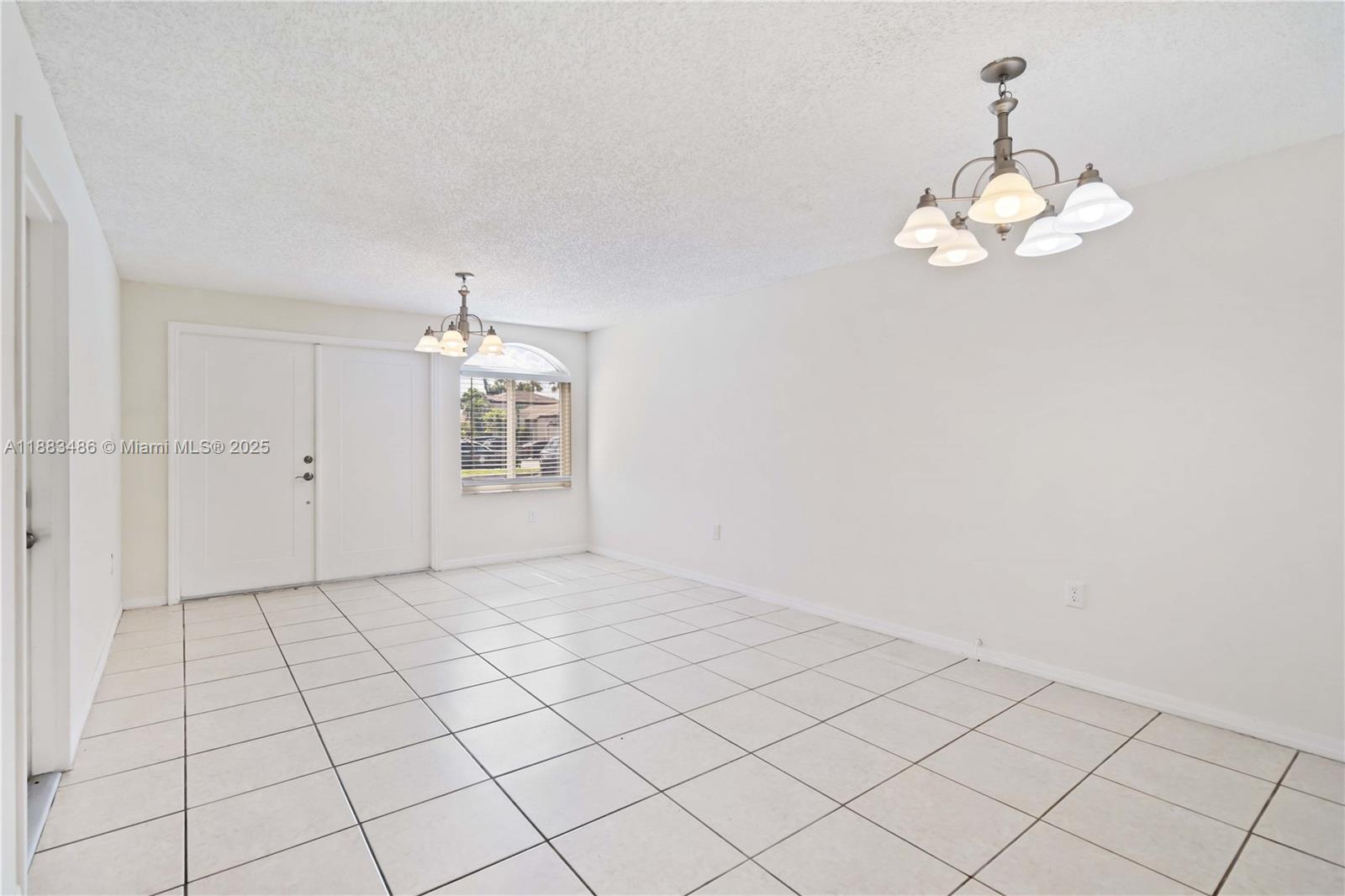 8431 Northwest 188th Terrace, Unit 8058 Hialeah, FL 33015 - Photo 6 of 34 an empty room with kitchen view