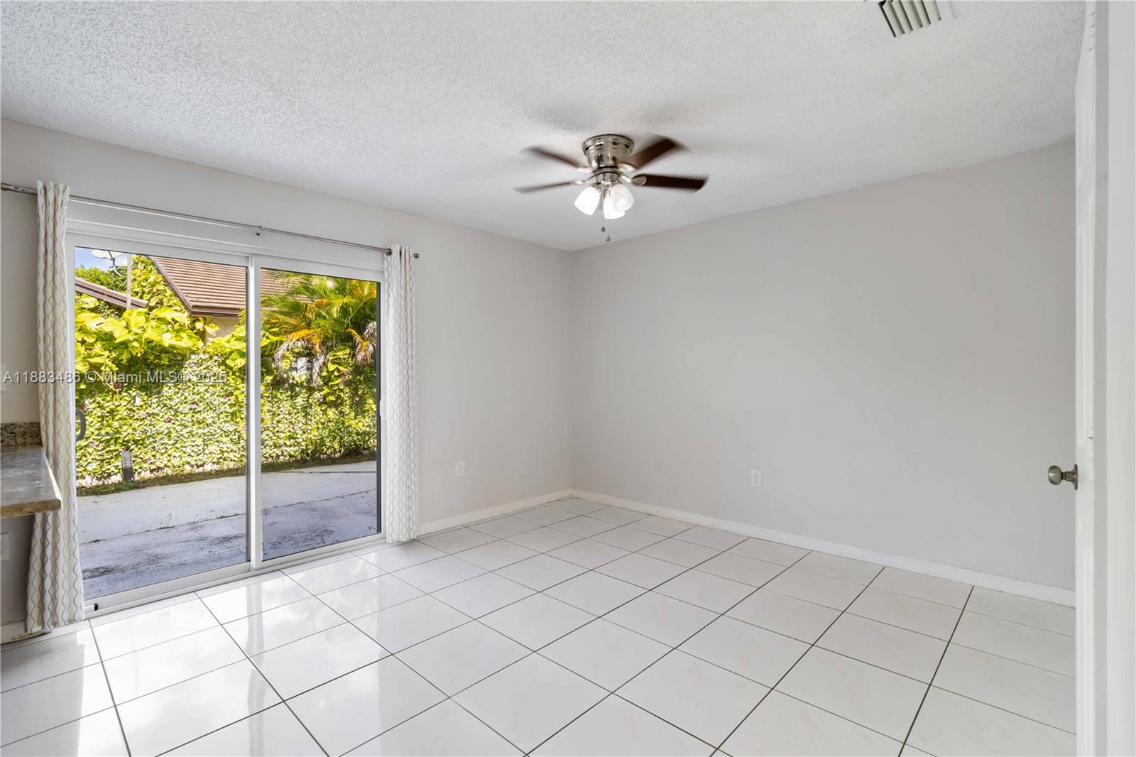 8431 Northwest 188th Terrace, Unit 8058 Hialeah, FL 33015 - Photo 8 of 34 an empty room with windows