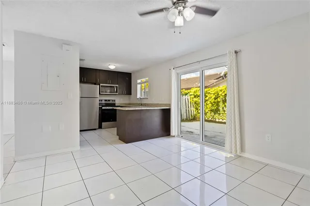 a view of a kitchen with microwave and a stove top oven
