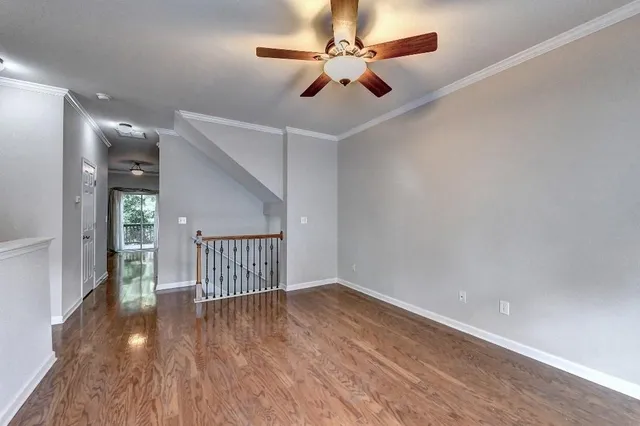 a kitchen with refrigerator cabinets and wooden floor
