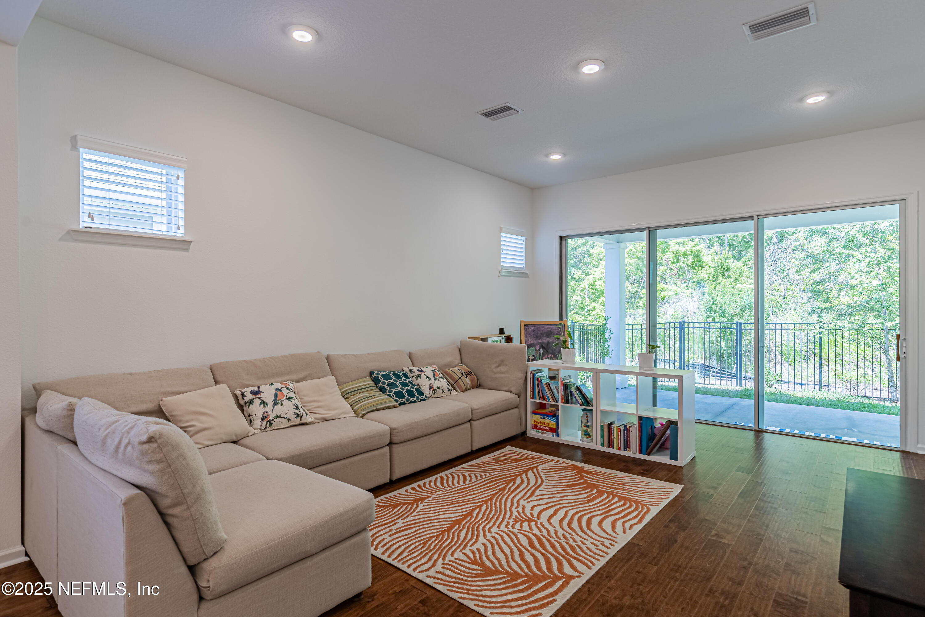 383 Windswept Way Street St. Augustine, FL 32092 - Photo 16 of 34 a living room with furniture and a floor to ceiling window