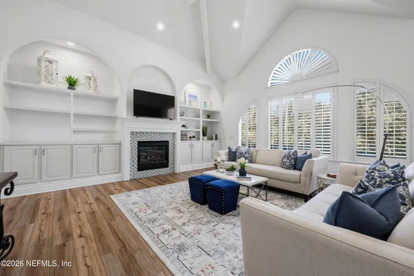 a living room with furniture a window and a potted plant