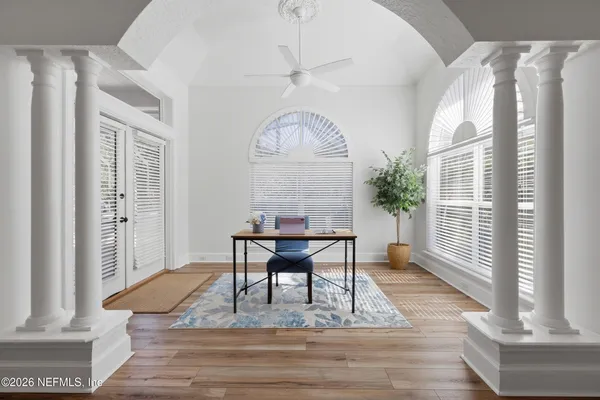 a view of a brick house with a chairs and table in a patio