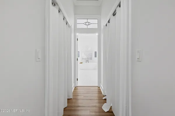 a view of a patio with a table and chairs under an umbrella