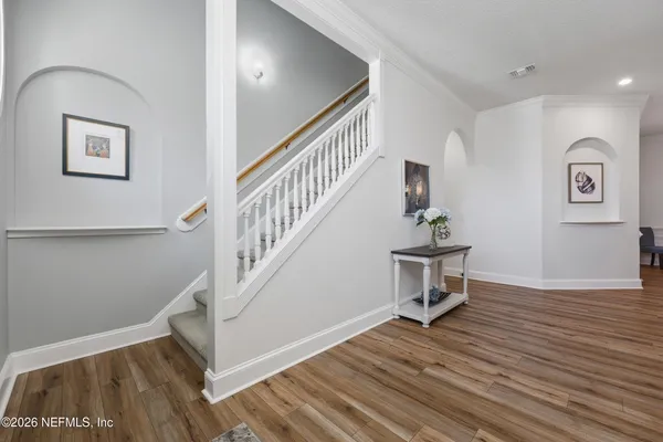 a front view of a house with a yard and potted plants