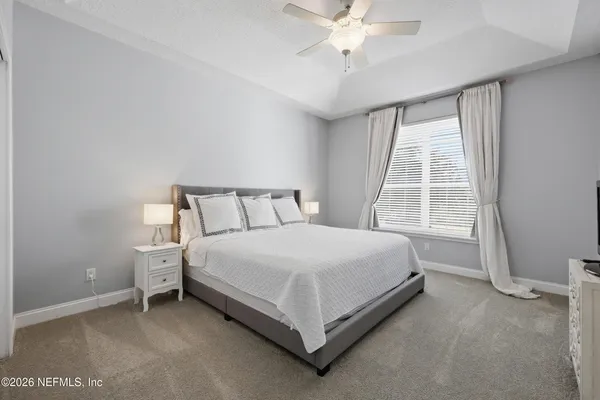 a view of a building with a yard and sitting area