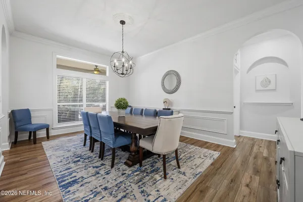 a kitchen with kitchen island granite countertop a sink stainless steel appliances and white cabinets