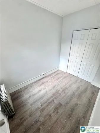 a view of room with window and wooden floor