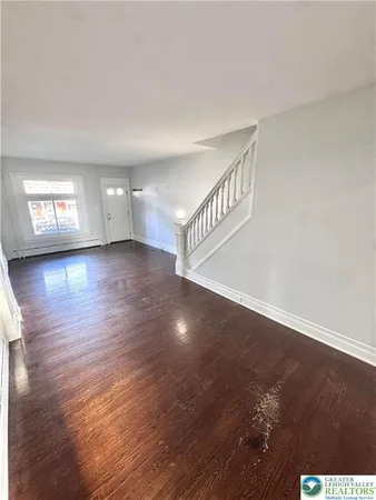 a kitchen with stainless steel appliances a refrigerator a sink a stove a microwave and wooden floors