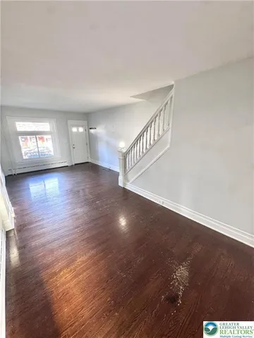 a kitchen with stainless steel appliances a refrigerator a sink a stove a microwave and wooden floors