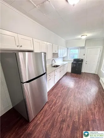 a kitchen with a sink a stove and cabinets