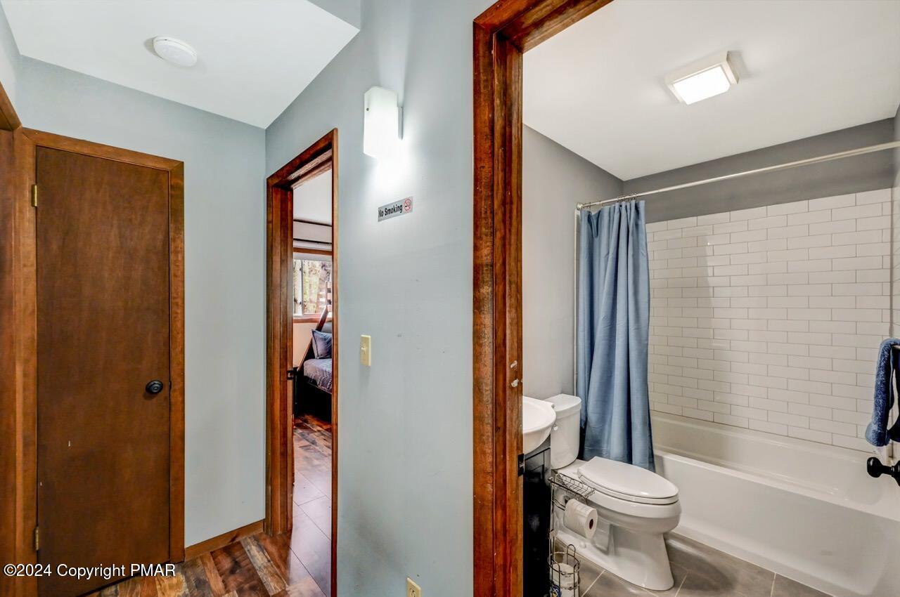 209 Kit Carson Circle Pocono Pines, PA 18350 - Photo 26 of 44 a bathroom with a toilet and a shower