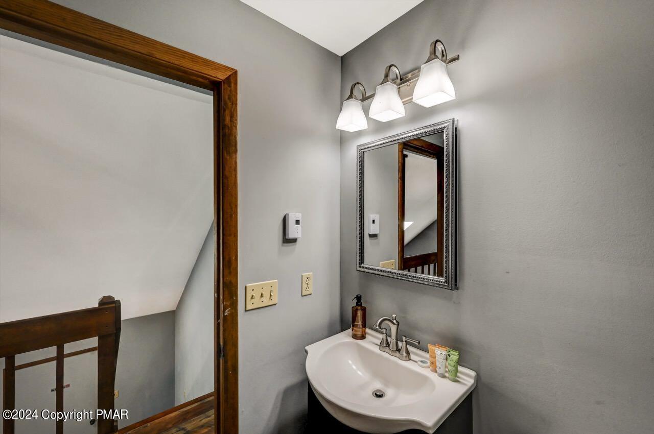 209 Kit Carson Circle Pocono Pines, PA 18350 - Photo 27 of 44 a bathroom with a sink and a mirror