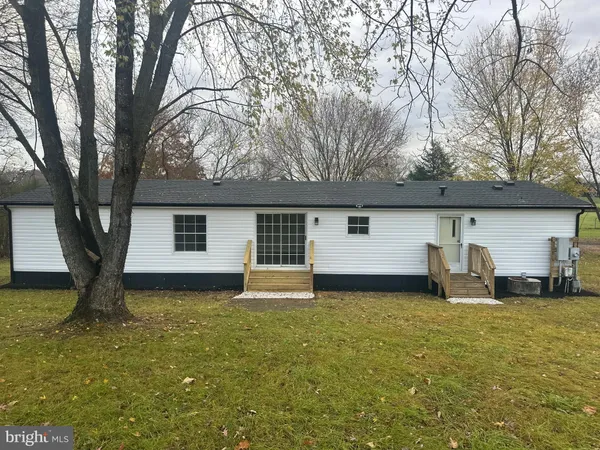 a house that has a tree in front of it