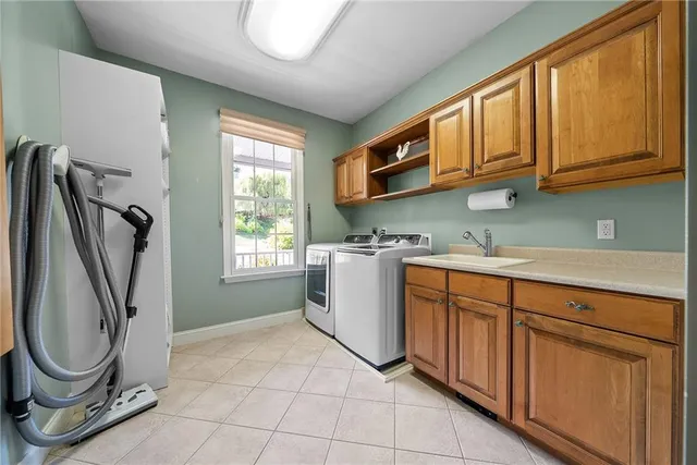 a utility room with cabinets a washer and dryer