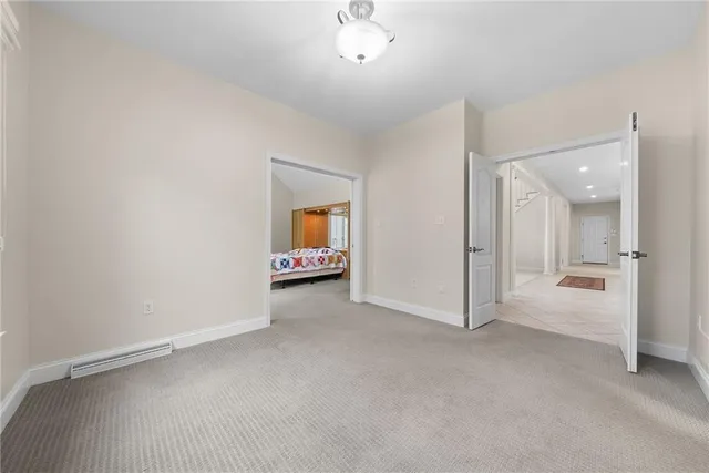 a view of an empty room and a bathroom