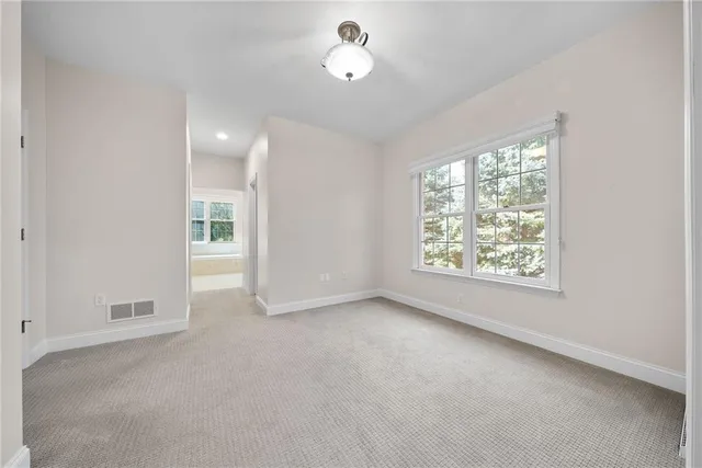 an empty room with windows and closet