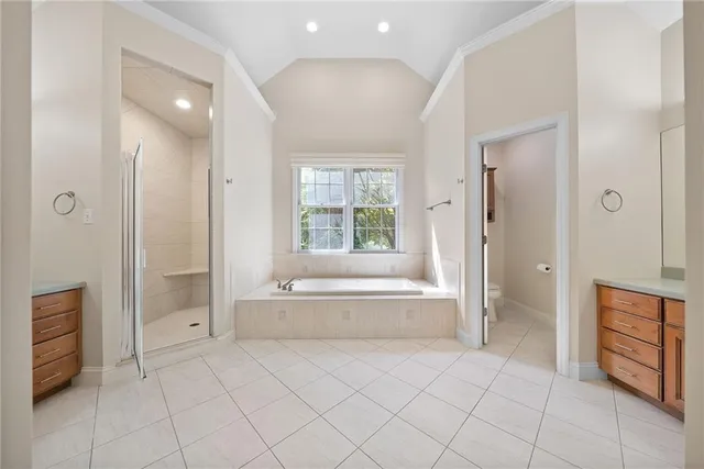 a spacious bathroom with a tub shower and sink